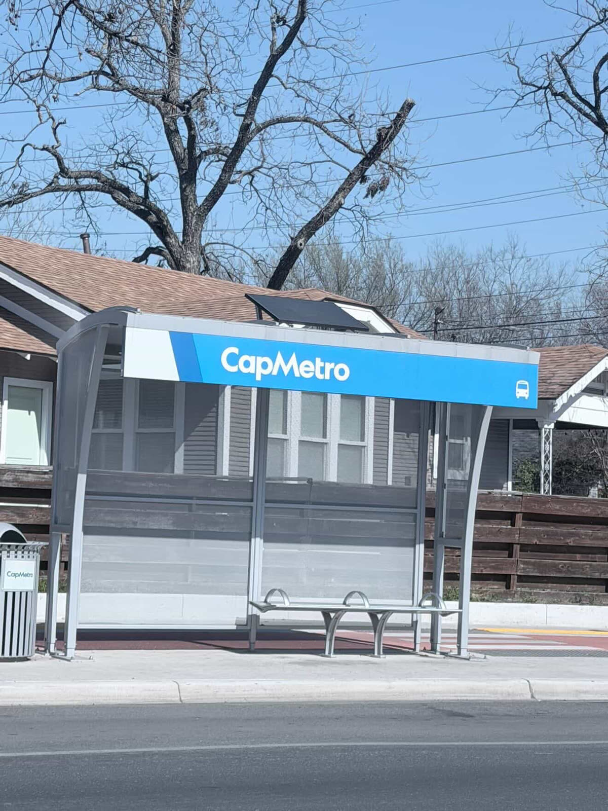 Solar passenger shelter installed beside an active transit route